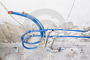 Water pipes made of polypropylene PEX in the wall, plumbing in the house. Installation of sewer pipes in a bathroom of an apartmen