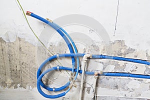 Water pipes made of polypropylene PEX in the wall, plumbing in the house. Installation of sewer pipes in a bathroom of an apartmen