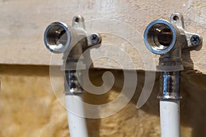 Water pipes made of polypropylene in the wall, plumbing in the house. Installation of sewer pipes in a bathroom of an apartment in