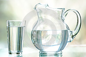 Water Pitcher and Glass with a Natural Background