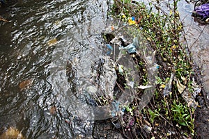 Water pollution. Garbage in the urban stream