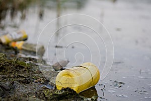 Water pollution - plastic bottle on river surface