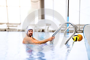 Water polo player in a swimming pool.