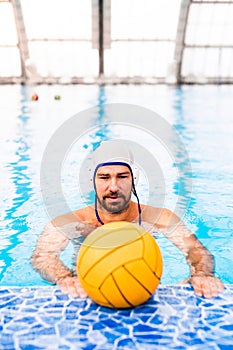 Water polo player in a swimming pool.