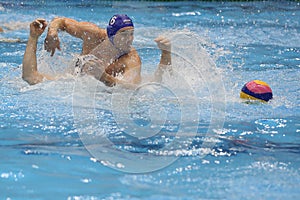 Water polo players fighting for the ball