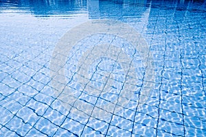 Water pool background. Blue wave pool texture, clear water surface. Abstract summer sea pattern.