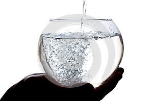 Water is poured into a large glass