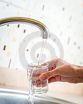 Water poured from tap to glass