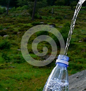 Water pouring into bottle