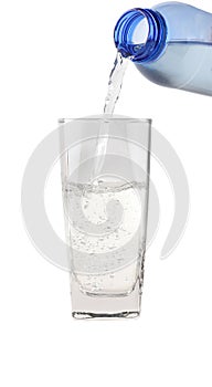 Water pouring into the clear glass isolated on white background