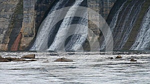 Water pouring through hydroelectric dam on the Catawba River in Fort Mill, South Carolina, USA. Slow motion water flowing down con