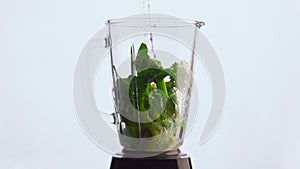 Water pouring vegetable blender super slow motion close up. Fresh veggies fruits