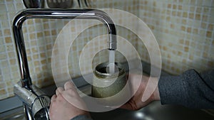 water is pouring water into a moka pot