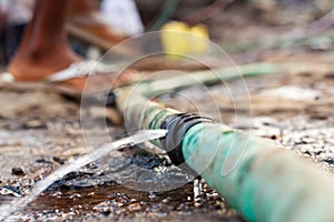 Water pours out of a leaky pipe