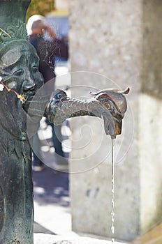 Water, a precious resource that comes out of a human and dragon face shaped fountain