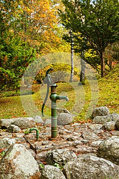 Water pump in a garden in autumn