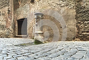 Water Pump on the Paved Streets of Rome Italy