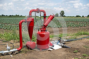 Water pump and pipes on farmland