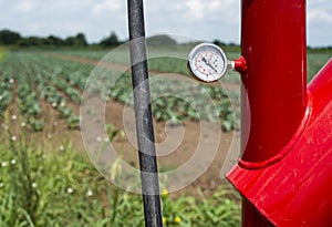 Water pump and pipes on farmland