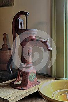 The water pump in a primitive colonial style Kitchen
