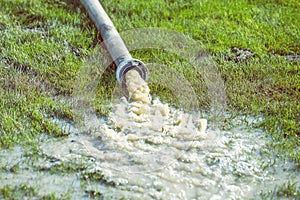 Water pumping rainwater out of the excavation trenches