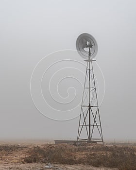 Water pumping windmill on a fogy morning in Texas