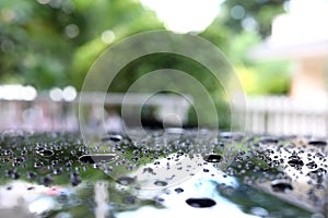 Water rain droplet on black car with glass coating