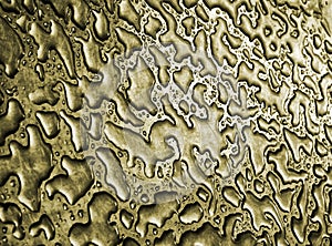 Water after rain on a gold metallic steel surface