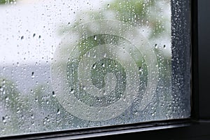 Water of Raindrops fresh on surface window glass in rainy season Selective focus