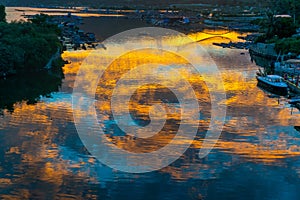 Water reflecion of Amazing flaming red fire in the sky cloudscape background