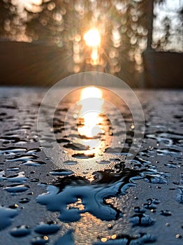 Water reflection on rain drops during sunset