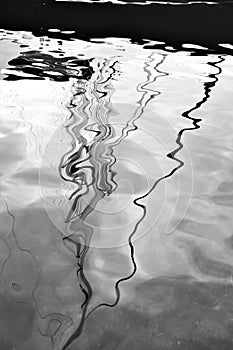 Water reflection of sail yacht with mast and tackle