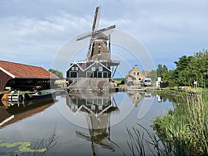 Water reflection of the windmill De Rat