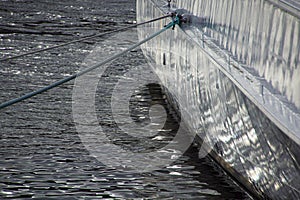 water reflects on the side of a ship