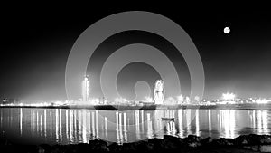 Water reflexion minaret, big wheel and full moon