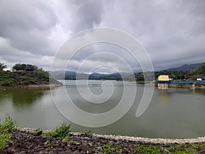Water reservoir lake with reflections from cloudy sky