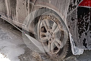 Water rinses off shampoo in a car wash, cleanliness and care of equipment
