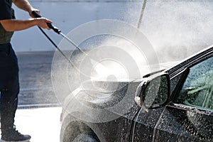 Water rinses off shampoo in a car wash, cleanliness and care of equipment