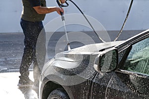 Water rinses off shampoo in a car wash, cleanliness and care of equipment