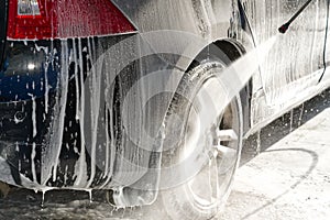 Water rinses off shampoo in a car wash, cleanliness and care of equipment