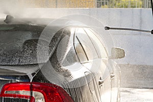Water rinses off shampoo in a car wash, cleanliness and care of equipment
