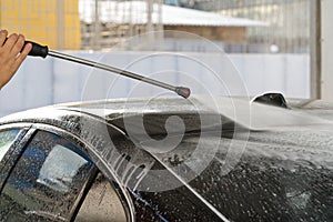 Water rinses off shampoo in a car wash, cleanliness and care of equipment