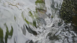 Water in river close up. Pebble stones in the river water close up view