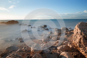 Water rocks and ocean at dusk