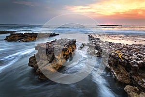 water and rocks at sunrise on the coast on nsw south coast of australi