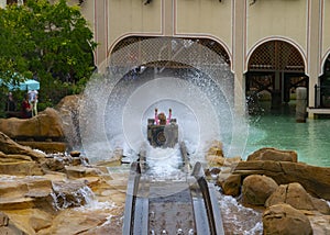 Water roller coaster ,people rising Hands.