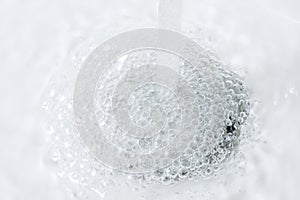 Water Running Down and Forming Bubbles on Sink Drain Hole
