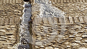 Water running down a Moor gutter in the streets of Frigiliana