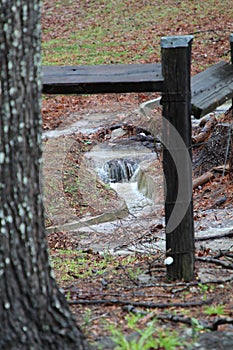 Water running over a slight drop into a drainage culvert after a particularly hard rain.