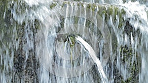 Water running and pipe expelling water in a natural water spring